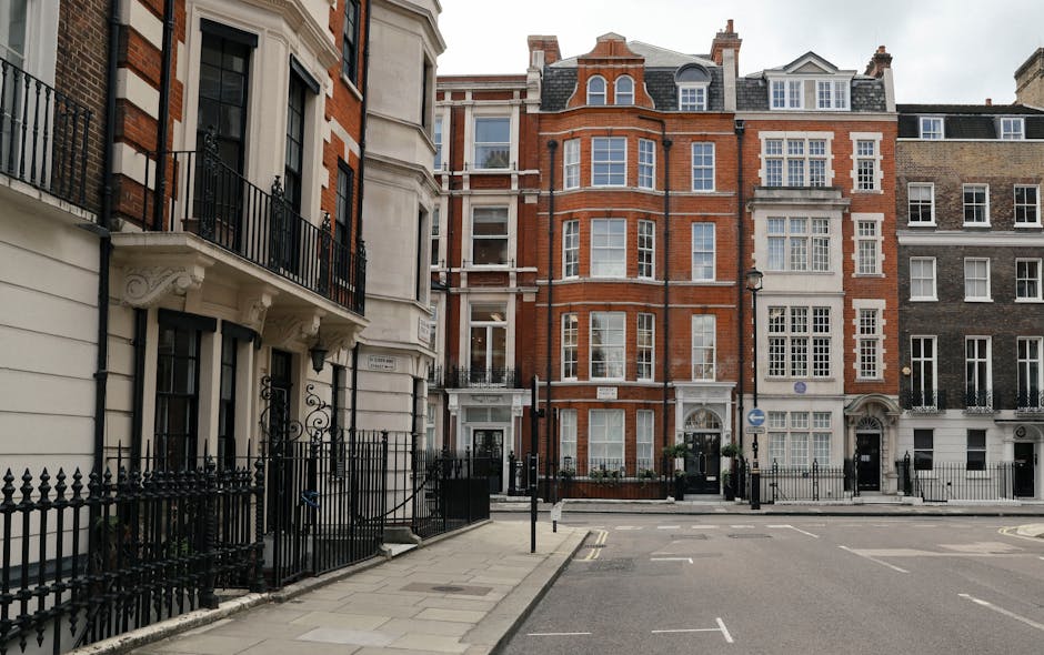 A street view in Belgravia featuring a row of multi-storey residential buildings with a mix of classic and modern architectural styles. The buildings are made of brick and stone, with large sash windo